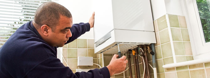 heating engineer working on boiler
